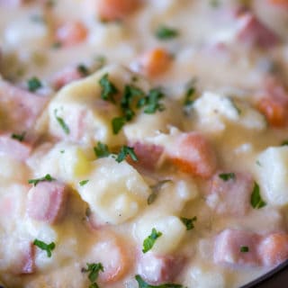 Slow Cooker Ham and Potato Soup that's creamy, full of vegetables and chunks of ham, finished off with milk and sour cream for a easy and delicious hearty soup.